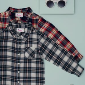Stylish kids plaid shirts with sunglasses and wallet on blue background.